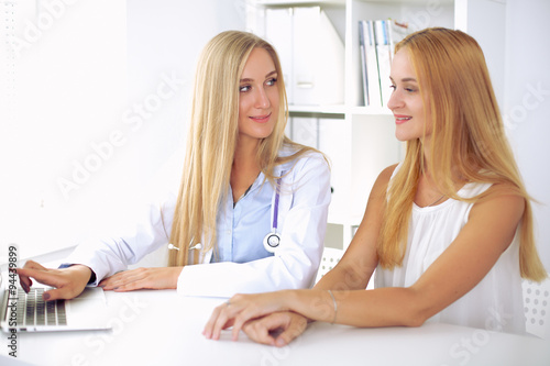 Doctor and patient are discussing something, just hands at the table 