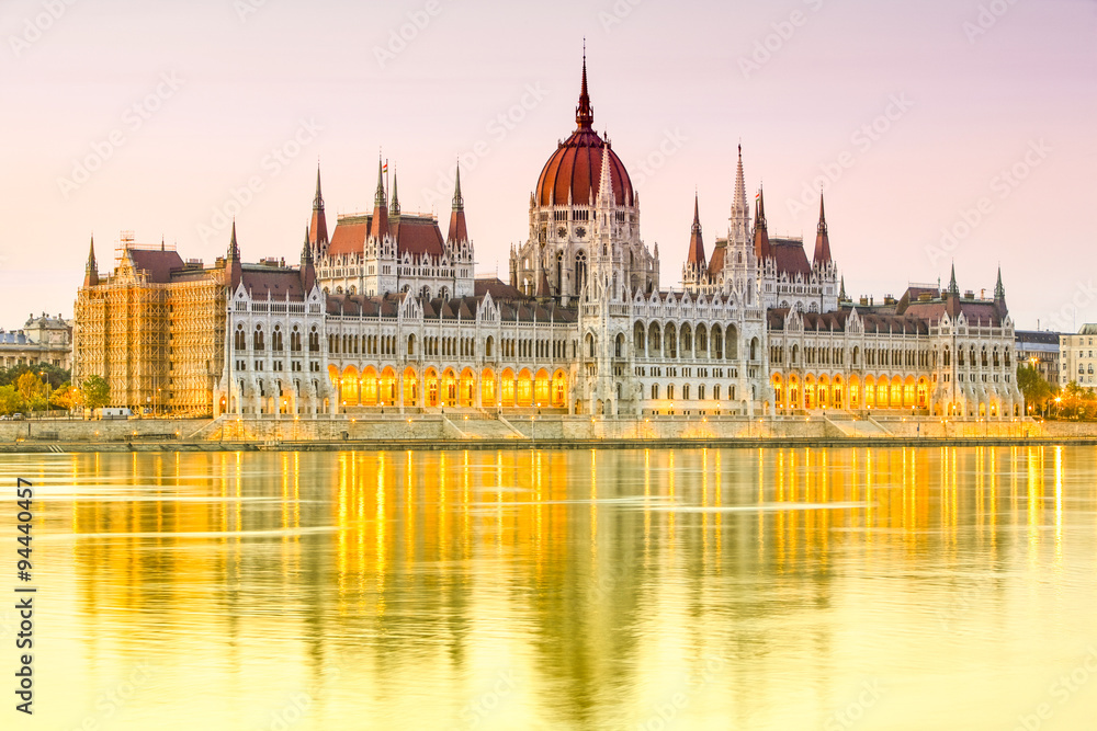 Experience the breathtaking beauty of the Hungarian Parliament Building at sunset in Budapest,Hungary,a must visit landmark for its stunning architecture and historical significance.