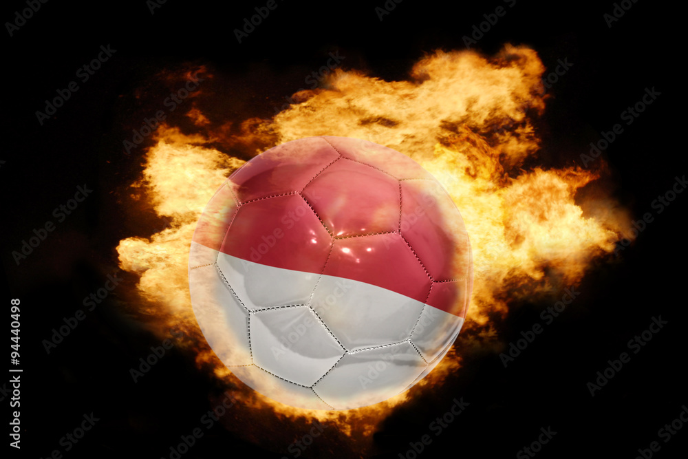 football ball with the flag of indonesia on fire - obrazy, fototapety, plakaty 