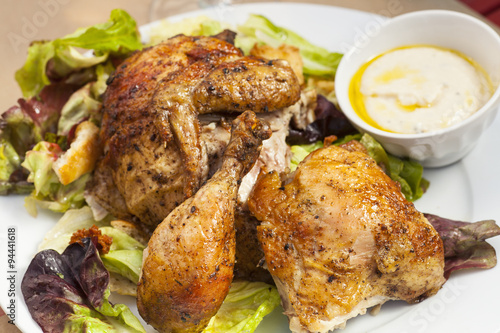 crispy free-range rotisserie chicken on organic butterleaf salad