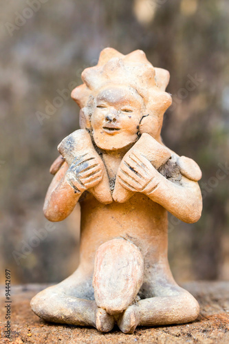 Uncover the intriguing artifact of a ceramic male figure symbolizing a woman holding two hammers a fascinating relic from Ecuador's ancient Tolita culture dating back to 500 BCE to 500 CE photo