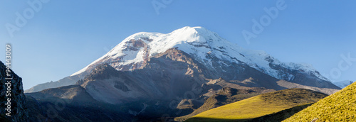 A majestic view of Chimborazo, Ecuador's highest volcano and mountain, with its towering peak surrounded by mist at high altitude.