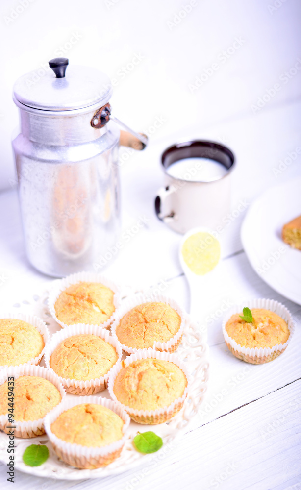 Cornbread muffins and milk on white table Cornbread muffins and milk on white table