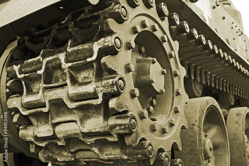Tracked military equipment close-up, toned