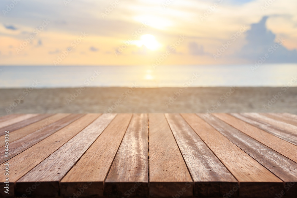 Top of wooden table at sunset beach. Can use for product display Top of wooden table at sunset beach. Can use for product display