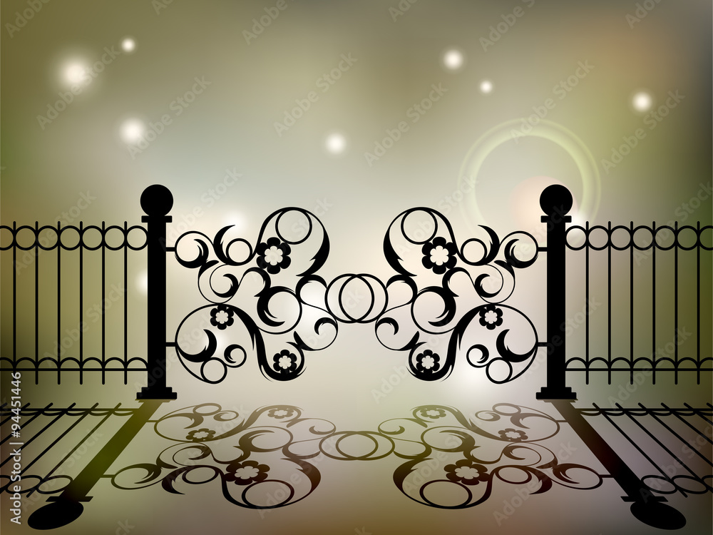 Wrought iron gate with an elegant floral designs on the blur background