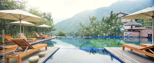 Umbrella chair in hotel pool resort with sunset © zhu difeng