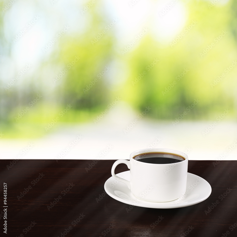 Cup of coffee on table on bright background Cup of coffee on table on bright background
