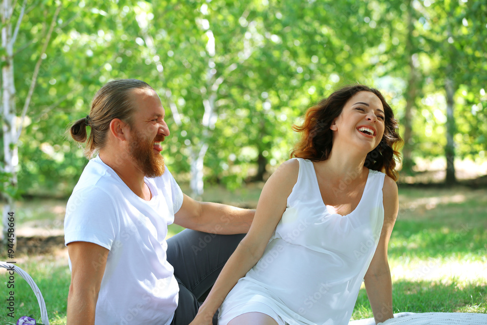 Happy couple on white blanket in the park, close up Happy couple on white blanket in the park, close up