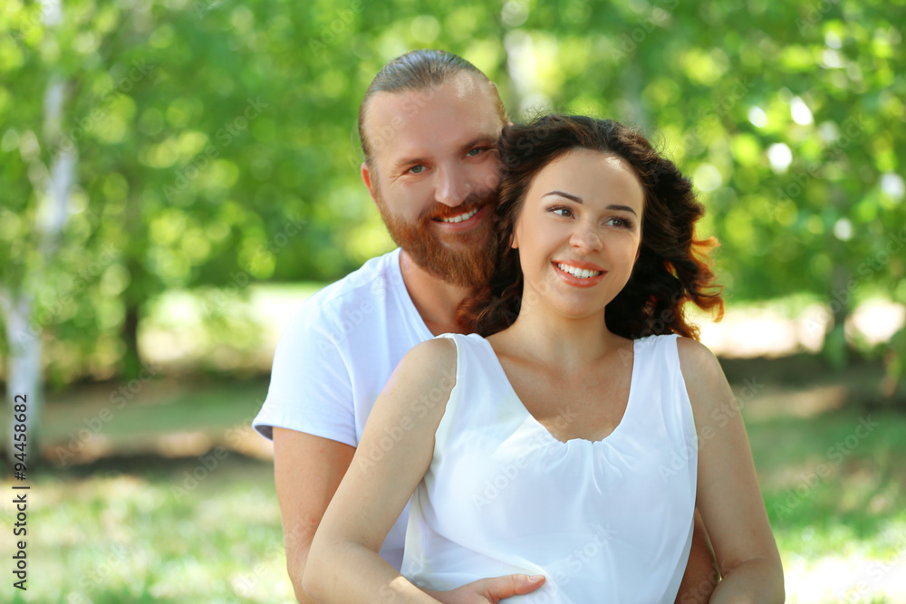 Portrait of embracing couple in the park, close up Portrait of embracing couple in the park, close up