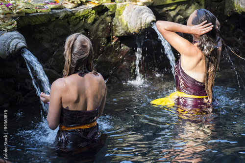 Travellers praying and take a bath at holy spring water.