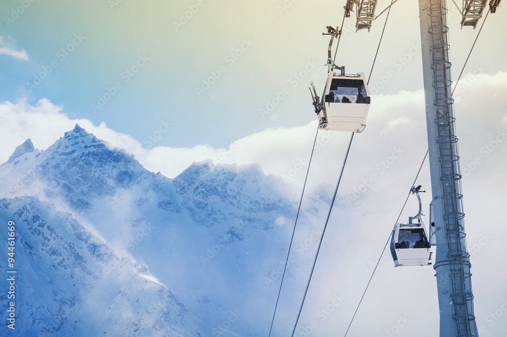 Cable car on the ski resort and snow-covered mountains