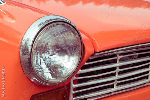 close-up headlight of colourful classic car © sutichak