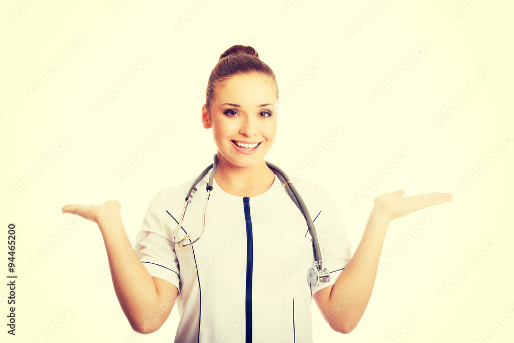 Female doctor presenting copyspace in both hands Female doctor presenting copyspace in both hands