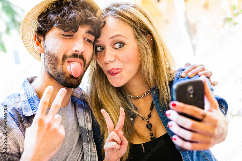 Fototapeta premium Funny Selfie, Couple of Hipsters Having Fun with Smartphone Phot