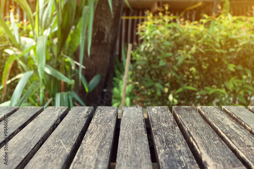 old table wood plank with green natural blurred background