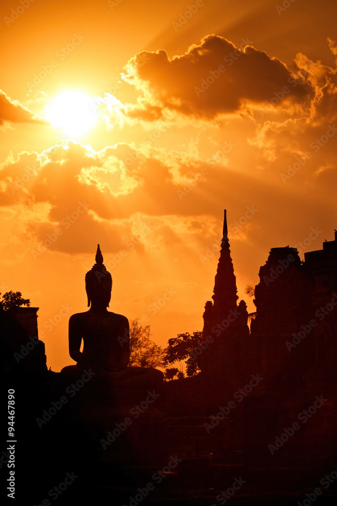 Silhouette of Buddha in a temple at Thailand evening.