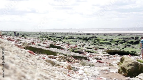 People Walking on Rocky Beach Seaside in Old Hunstanton, Norfolk, UK
 photo