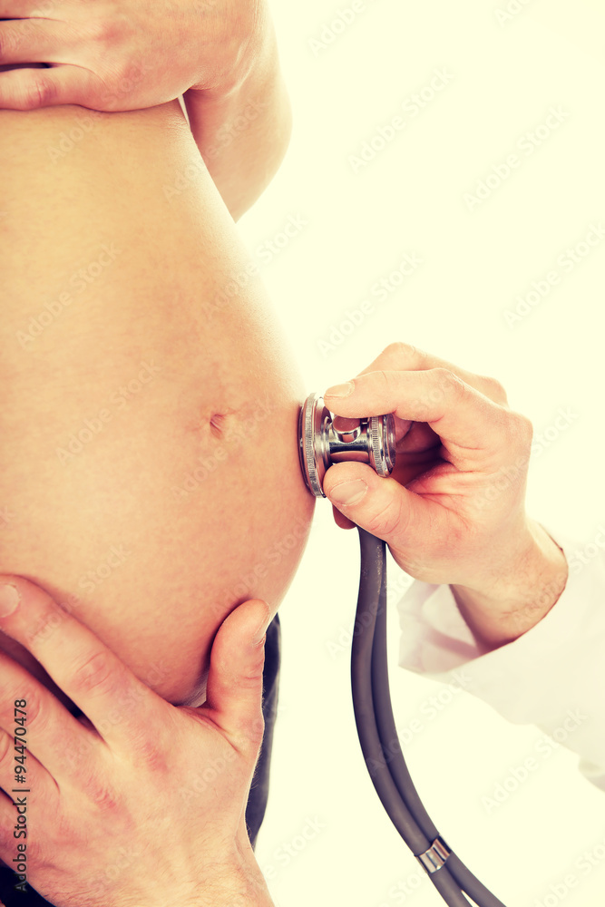 Fototapeta premium Pregnant woman being examine by doctor