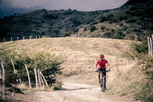 Mountain bike rider on country road, track trail in inspirationa