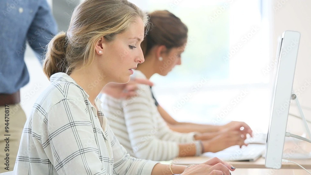 Student girl with teacher working on desktop computer Student girl with teacher working on desktop computer