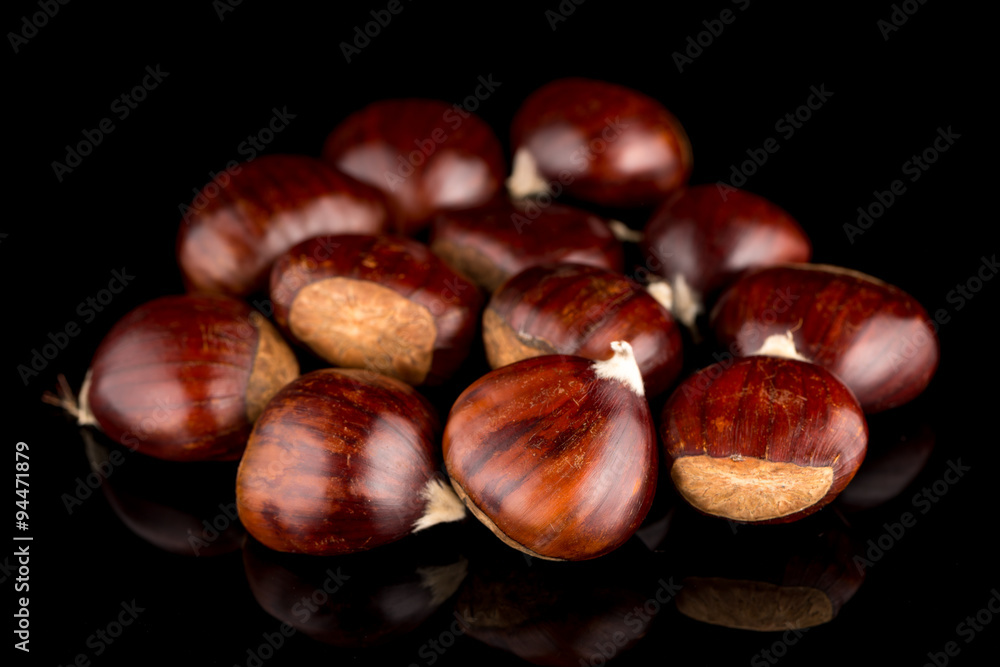 Chestnuts on a black reflective background Chestnuts on a black reflective background