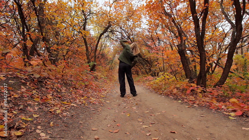 Blonde girl does excercises in the autumn forest Blonde girl does excercises in the autumn forest