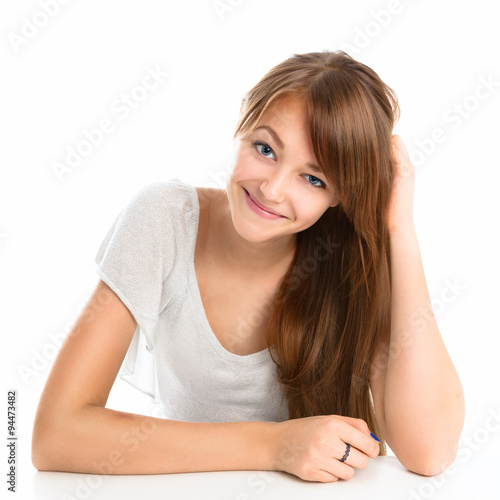 Portrait of a beautiful young smiling girl on a light background.