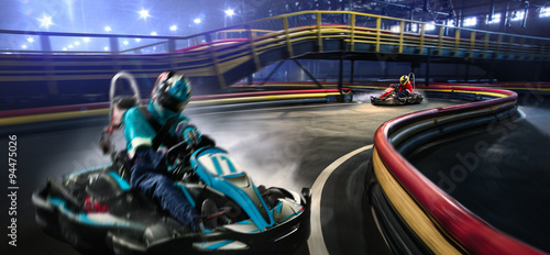 Two cart racers are racing on the grand track photo