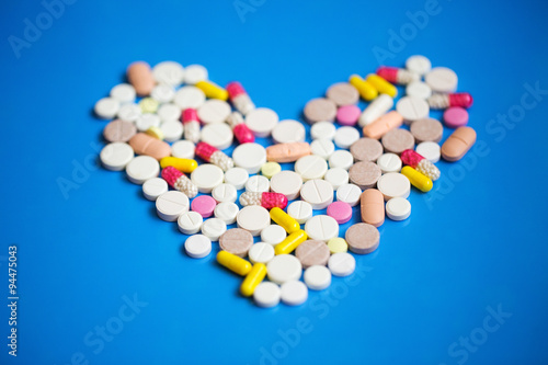 Pills in a heart shape close-up.