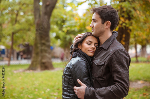 Couple hugging outdoors in park