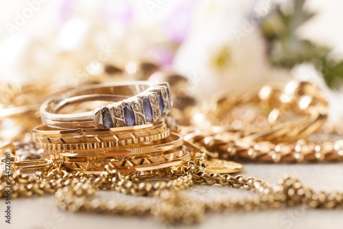 shiny gold and silver jewelery on white table
