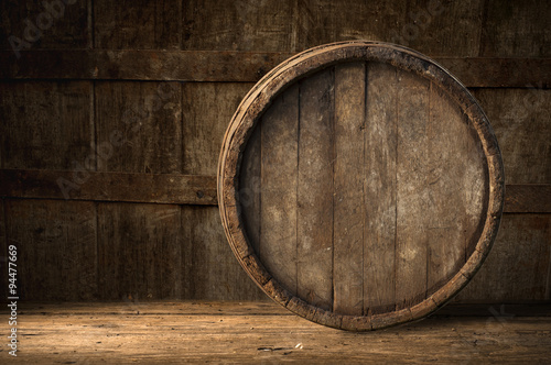 Beer barrel with glass on table wooden background