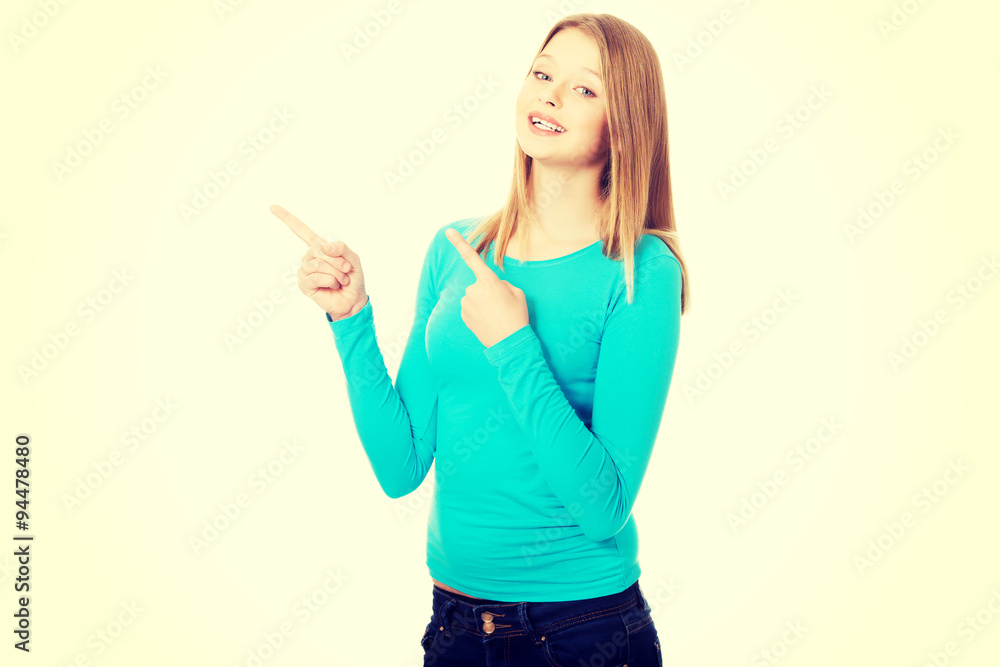 Young woman pointing with both hands Young woman pointing with both hands