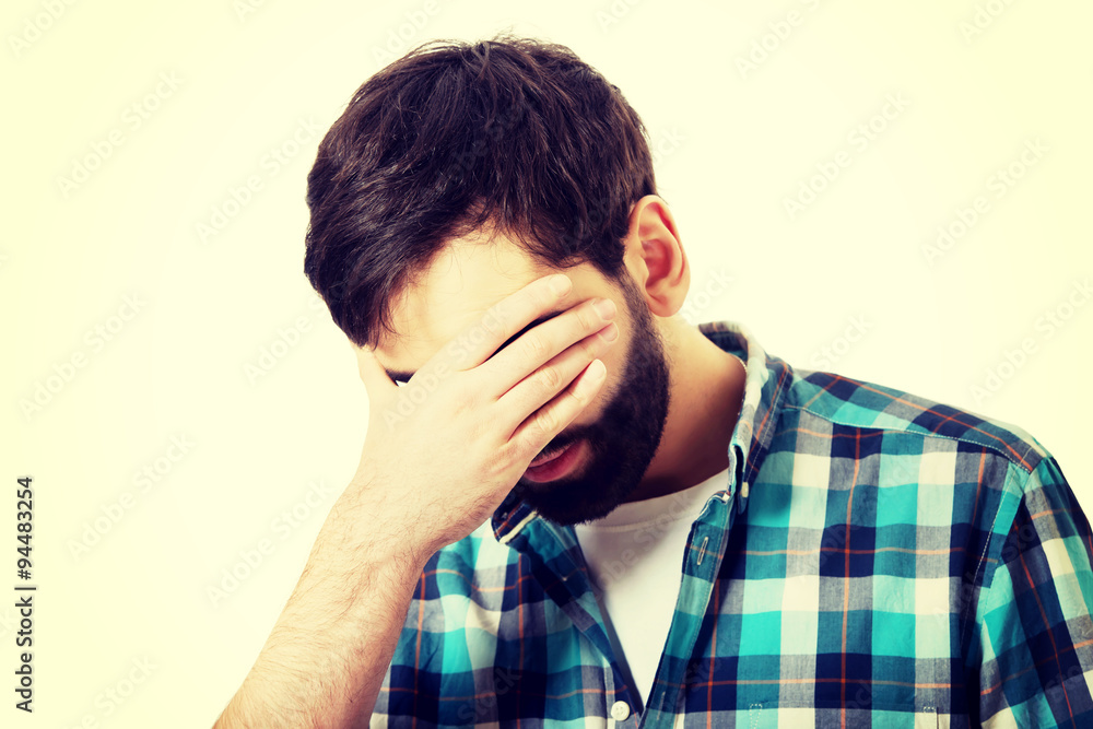 Young depressed man touching his face. Young depressed man touching his face.