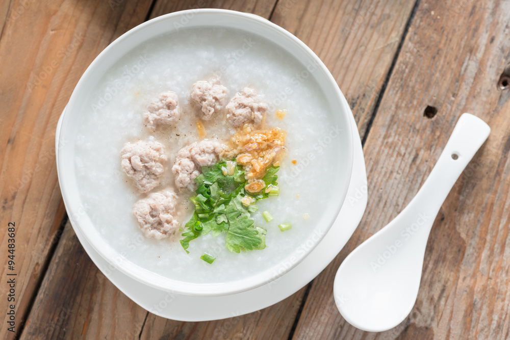 Asian congee with minced pork in white bowl. Top view. Asian congee with minced pork in white bowl. Top view.