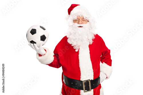 Studio shot of Santa Claus holding a football