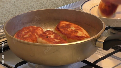 Female fry patties on skillet   photo