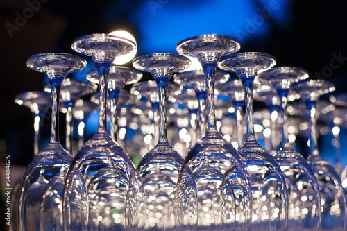 Empty wine glasses arranged in row, setup for wedding ceremony.