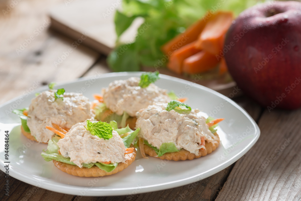 Crackers with tuna salad on white palte. Crackers with tuna salad on white palte.