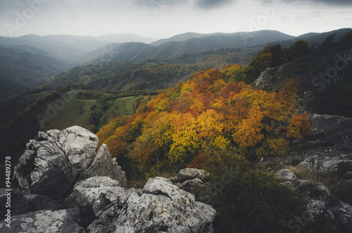 autumn landscape view over colorful forest and cliffs