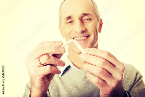 Successful man with broken cigarette