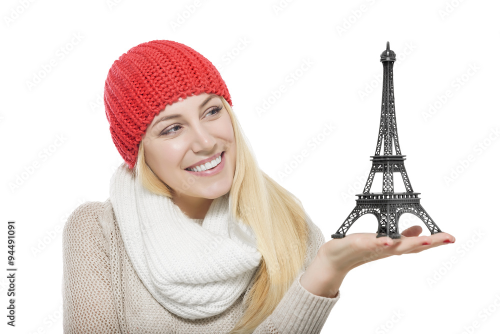 Beautiful blonde holding Eiffel Tower model.