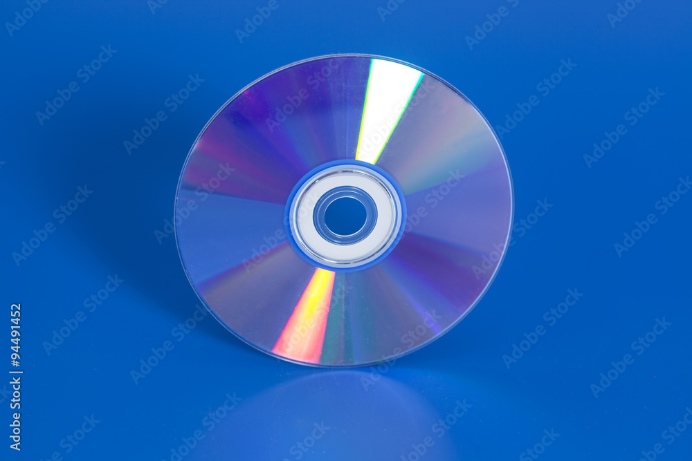 Compact disk on blue background Compact disk on blue background