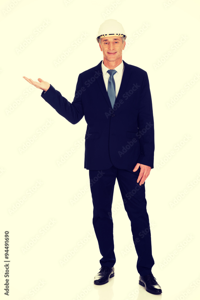 Businessman with hard hat holding copyspace Businessman with hard hat holding copyspace