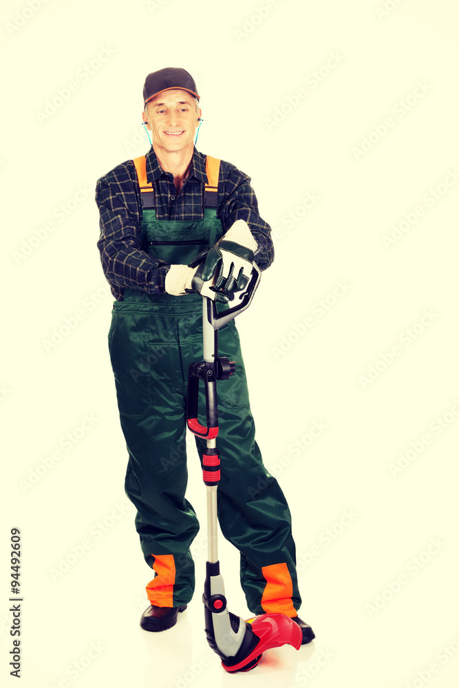 Gardener with trimmer and ear protectors Gardener with trimmer and ear protectors