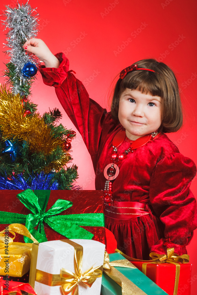 Nice child standing nearby Christmas tree Nice child standing nearby Christmas tree