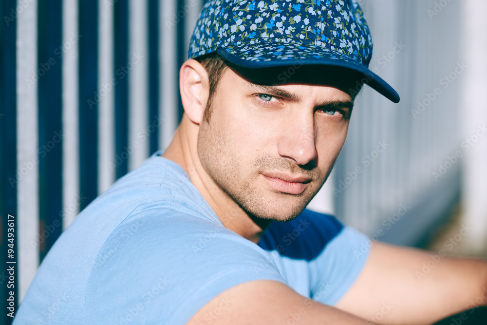 Man with blue eyes in trendy blue cap outdoors Man with blue eyes in trendy blue cap outdoors