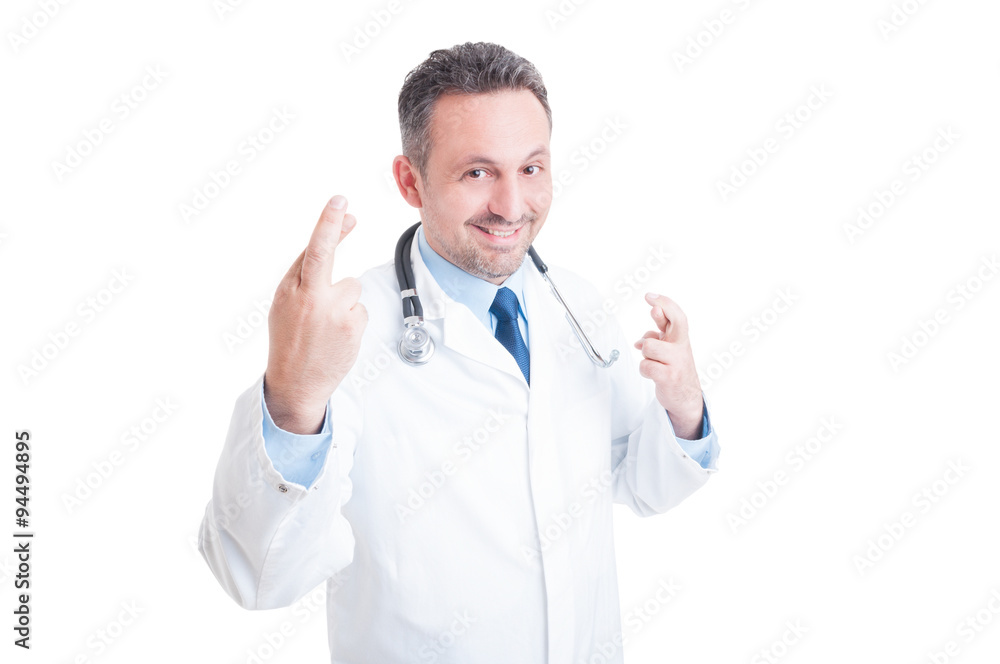 Male doctor making good luck gesture with crossed fingers Male doctor making good luck gesture with crossed fingers