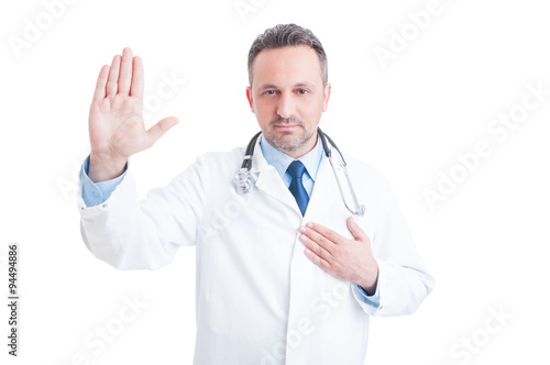 Confident and trustworthy medic or doctor making Hippocratic oat photo